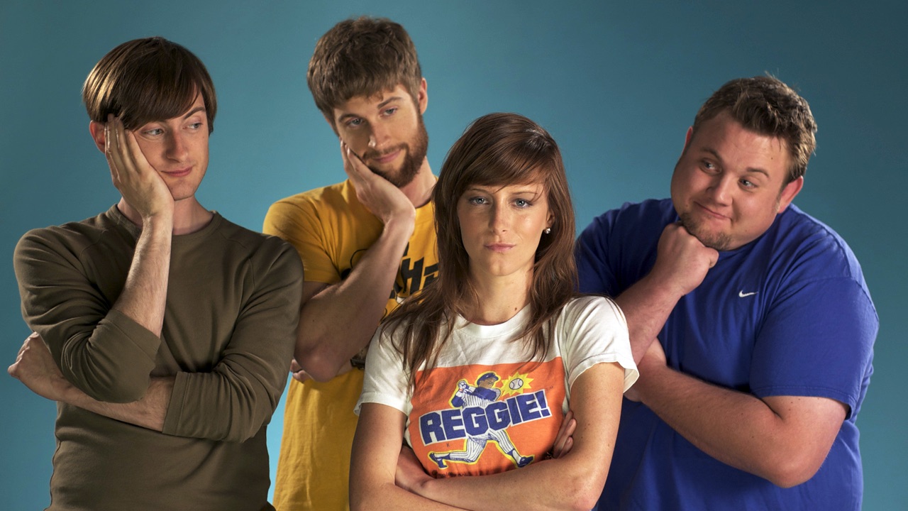 Four cast members strike a comedic pose against a teal backdrop in a promo still for Singledom