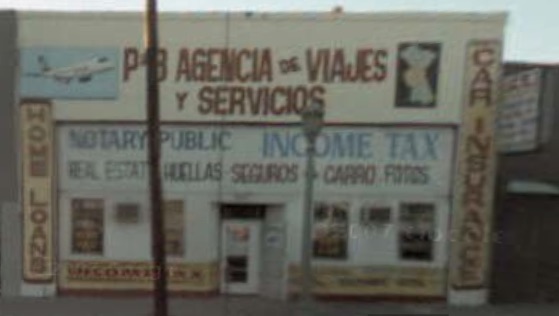 A storefront location with hand-painted travel agency and notary signage
